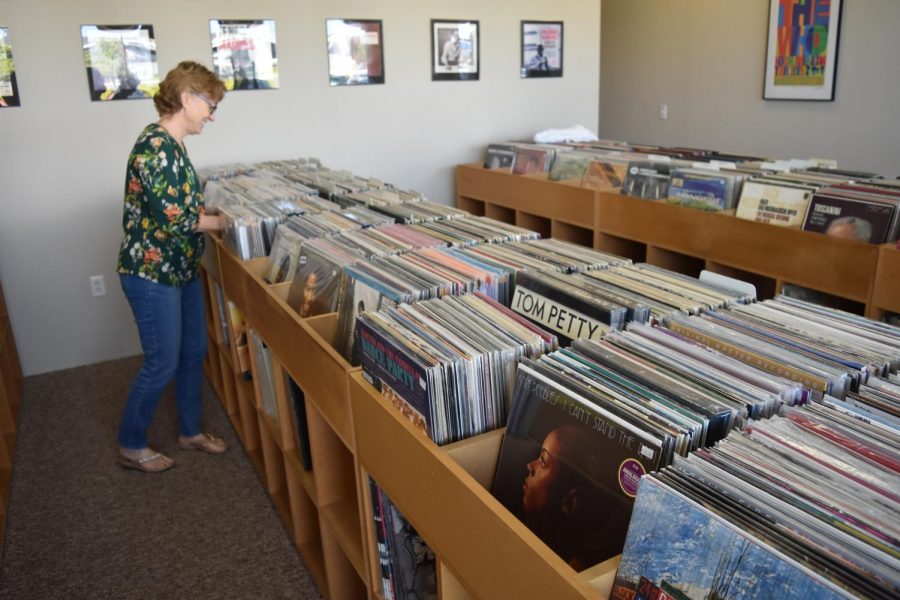 Kate Hartsell, co-owner of The Analog Room, sorts through vinyl LPs.