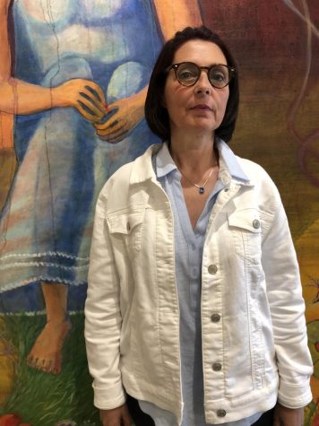 Marie Serda, 57, art major, has her painting The Blue Bird on display at the Euphrat Museum.  