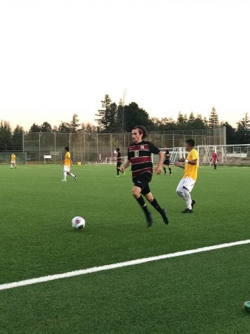 Luca Bravo, 19,
business major dribbling down the field.