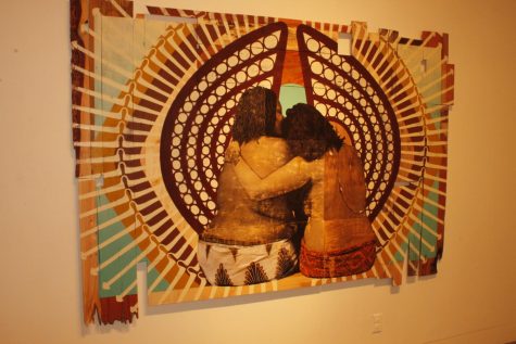 Jessica Sabogal and Shanna Strauss, “The Invisible Labor of Women of Color,” acrylic on found wood, depicts two queer women of color and size embracing.