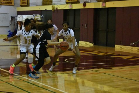 (Left #11) Danielle Gezzi, 20, kinesiology major and (Right #10) Anisah Douglas, 19, kinesiology major blocking opponent.