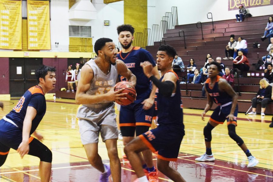 Kyle+Nelson%2C+21%2C+accounting+major+drives+to+the+basket+against+multiple+West+Valley+College+defenders+on+Jan.+24.