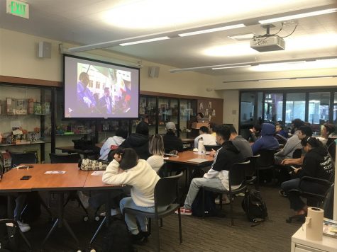 Students watch presentation on the Malayan Movement.