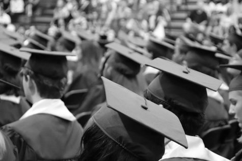 Students sitting in graduation attire