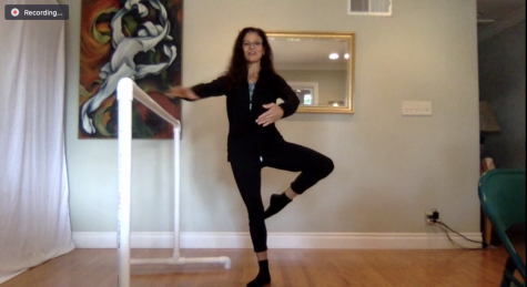 Marie Basile, dance instructor, demonstrates a passe in barre in front of her desk view camera.
