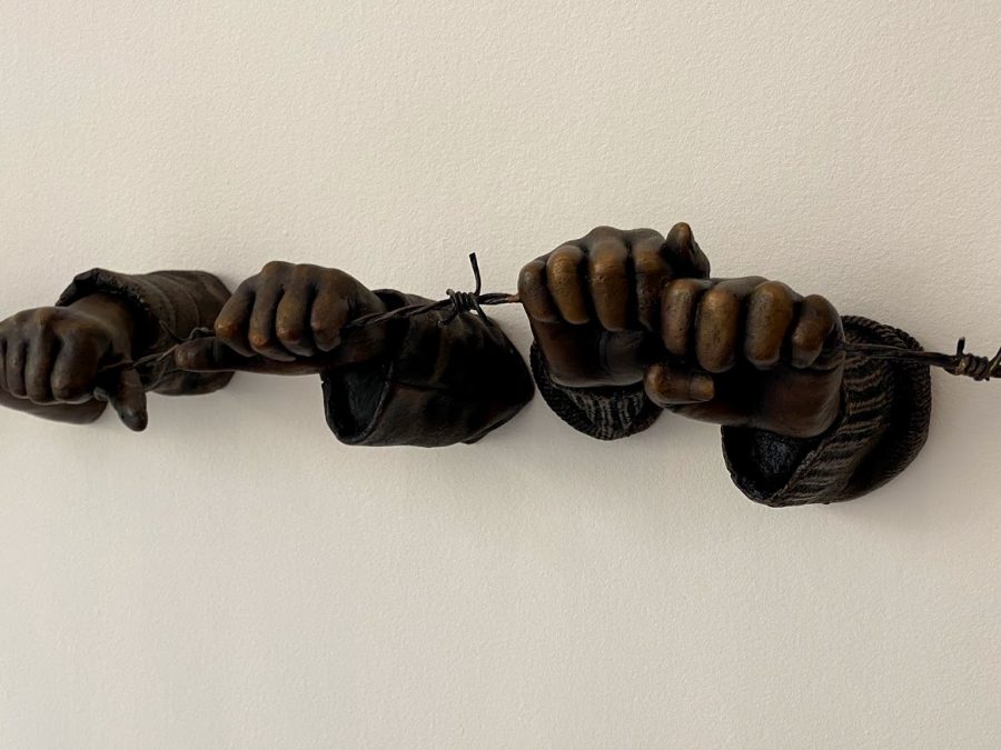 A photo of the bronze sculpture If the Leader Only Knew from Punctum series by Hank Willis Thomas, depicting hands grasping barbed wire.