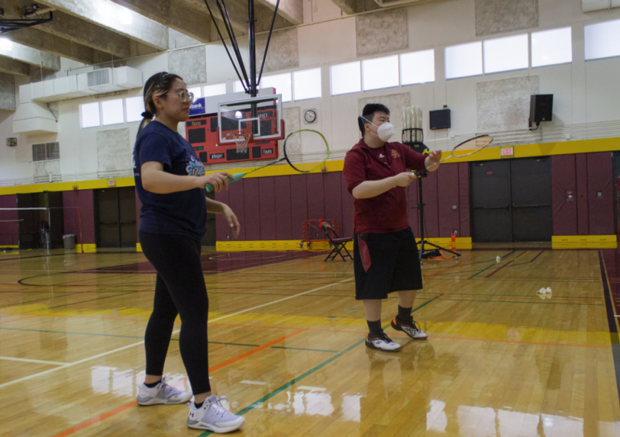 Assistant coach Jay Dinh (right) teaches a technique to  Kiana Torres Carrillo (left) at De Anza College on April 20.