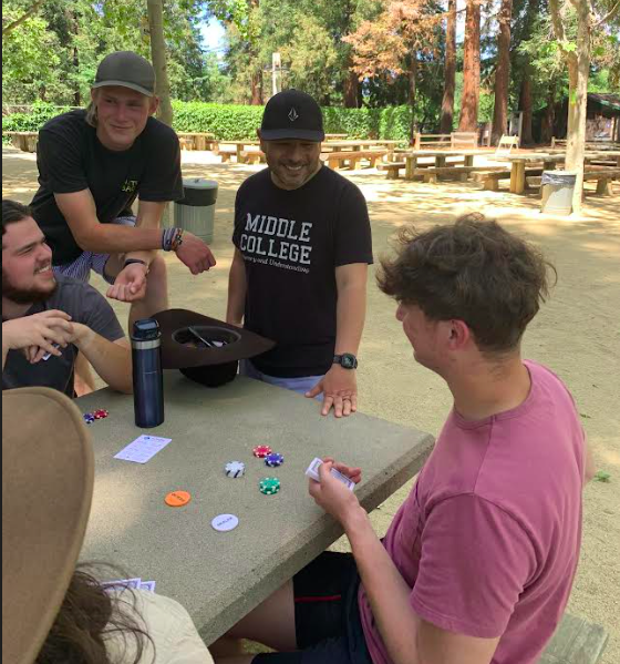 Marciano Gutierrez (wearing Middle College T-shirt) talks with his students at Cuesta Park in Mountain View during Community Park Day on May 19.