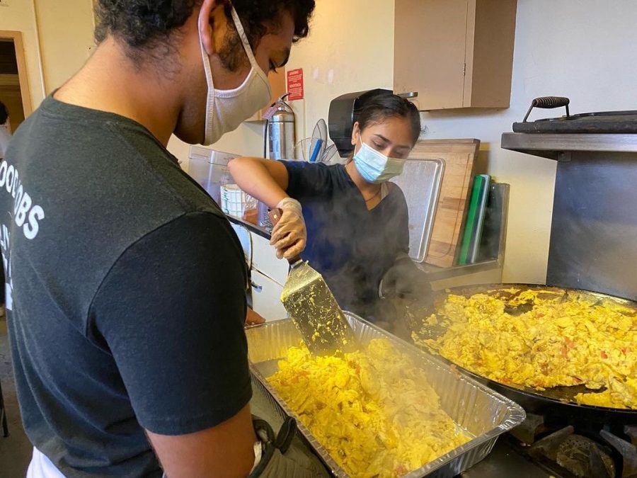 BSU members cooking scrambled eggs to distribute to unhoused residents later  on Nov. 20, 2021. The club partnered with BLACK Outreach, a San Jose based social justice and community service organization. Courtesy of Aminata Henry.