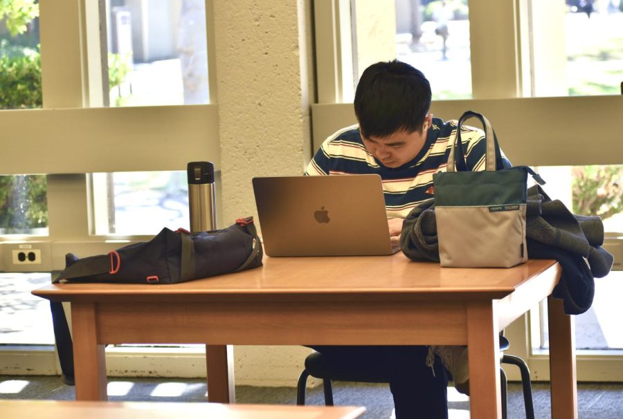 The new guidelines allow Jack Huang, 27, computer information systems major, to work on homework in the library without a mask. 