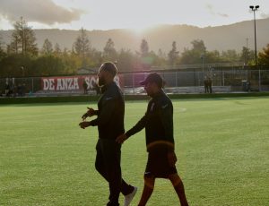 The mens soccer coaches, Mark “Rusty” Johnson (left) and Roheet “Roh” Sen (right), walking on the field after the first half of a soccer game on Nov. 4.