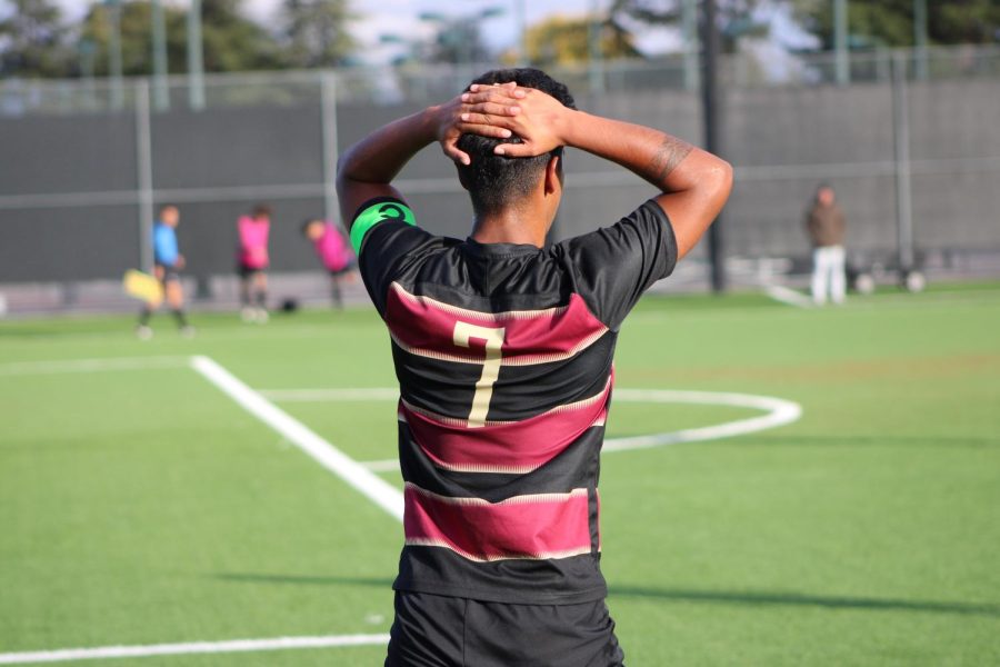 Cesar Cornejo taking a breather while playing against Cañada Colleges team at De Anzas soccer field on Nov. 4.