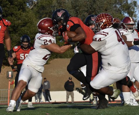 From left, Sebastian Davila, 24, pushes a Foothill player while Keyshawn Avila, 44, holds the Foothill player back on Nov. 19 at Foothill Colleges football stadium.