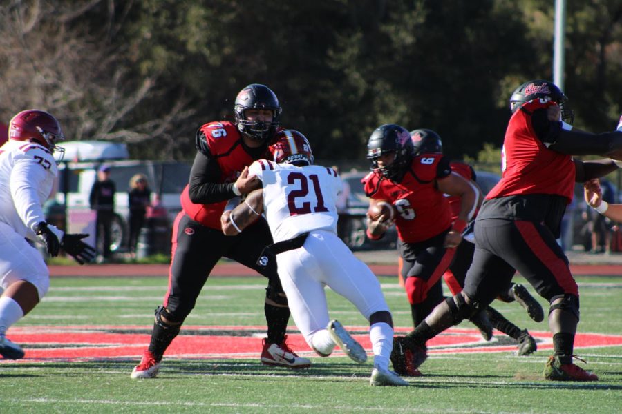 Keshawn Noriega, 21, linebacker for the De Anza College Mountain Lions, pushing a Foothill College player on Saturday, Nov. 19.