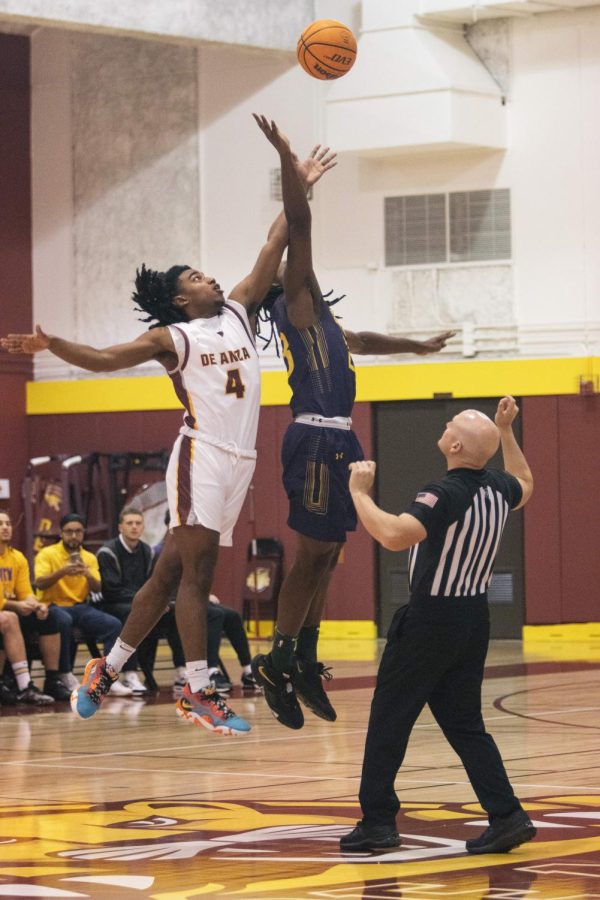 Guard DeBoyce Ware is tipping the ball off for the De Anza Mountain Lions on Wednesday, Jan. 11.