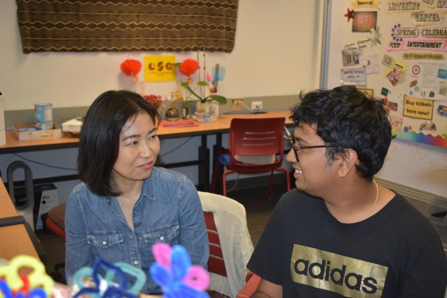 From left, Kanako Suda, an instructional support technician, and Praneet Vasishta, 19, psychology major, spend time at the Listening and Speaking Center on May 9.