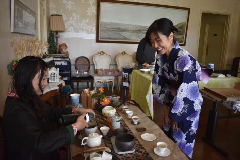 Lisa (Jiepin) Liao, 45, ESL student, performs a Chinese tea presentation and serves to Kanako Suda, an instructional support technician, during the Listening and Speaking Center spring celebration on June 9.