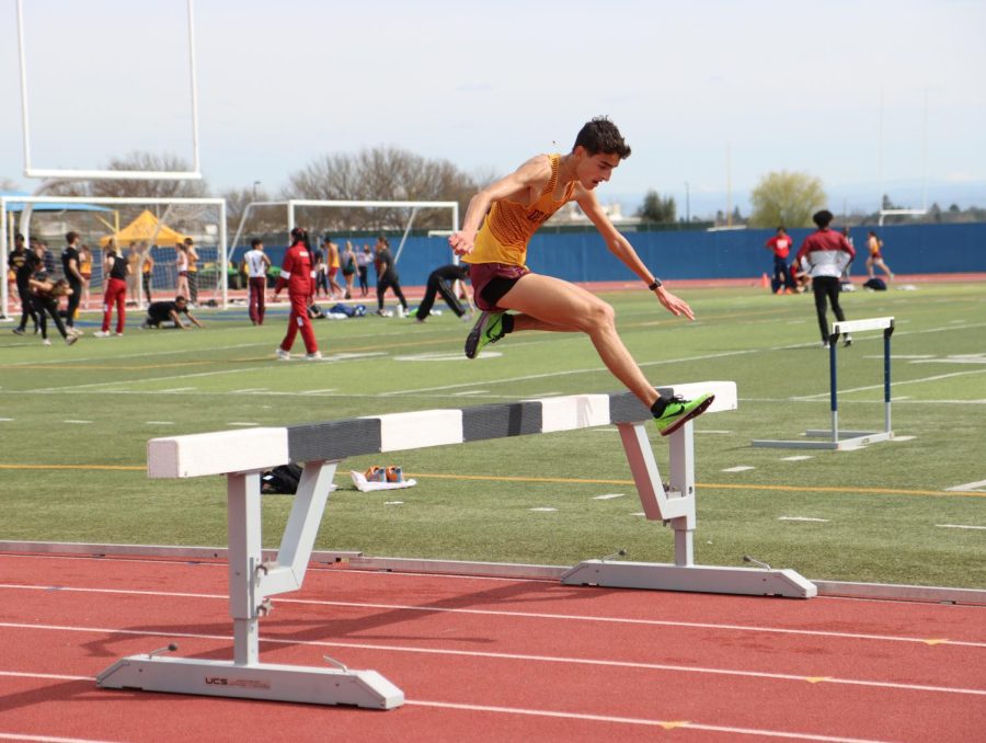 Antoine Moret, 19, aerospace engineering major, hurdling during the 3,000 meter steeplechase event at the Wildcat Cup meet on March 18.