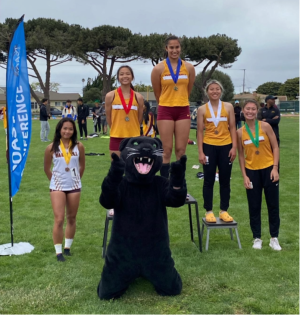 Brianna Nunn (center) stands with teammates at the track and field Coast Conference Championship at Hartnell College on April 29. Individuals from the team taped over “De Anza” on their jerseys in protest of the athletics department’s lack of support and communication after Head Coach Nick Mattis was placed on administrative leave.