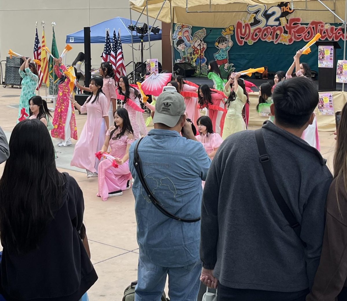 Visitors are taking pictures of Independence High School students performing fan dancing on Sept. 30 at Yerba Buena High School, San Jose.