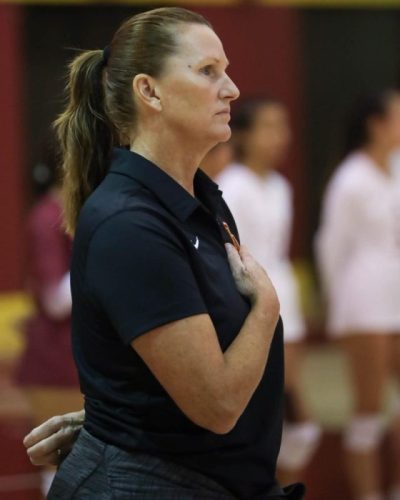 Womens volleyball coach Dawnis Guevara stands for the national anthem before the Oct. 27 game against City College of San Francisco.