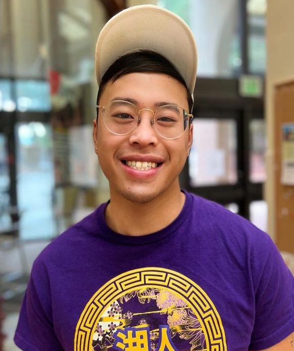 Henry Pham poses for the camera while visiting the Registration and Student Services building. 