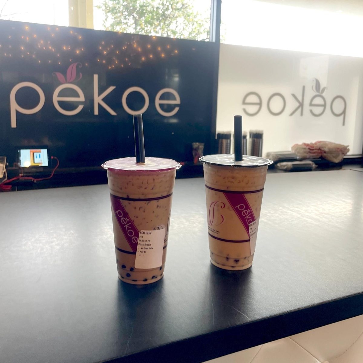 Two Pekoe teas sit on the bar in front of the Pekoe logo on Jan. 28.