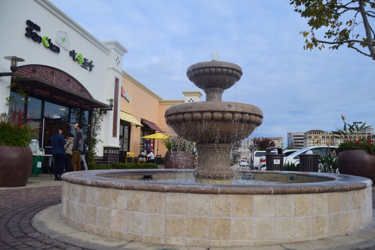 A fountain stands outside Chicha San Chen as customers come in and out.