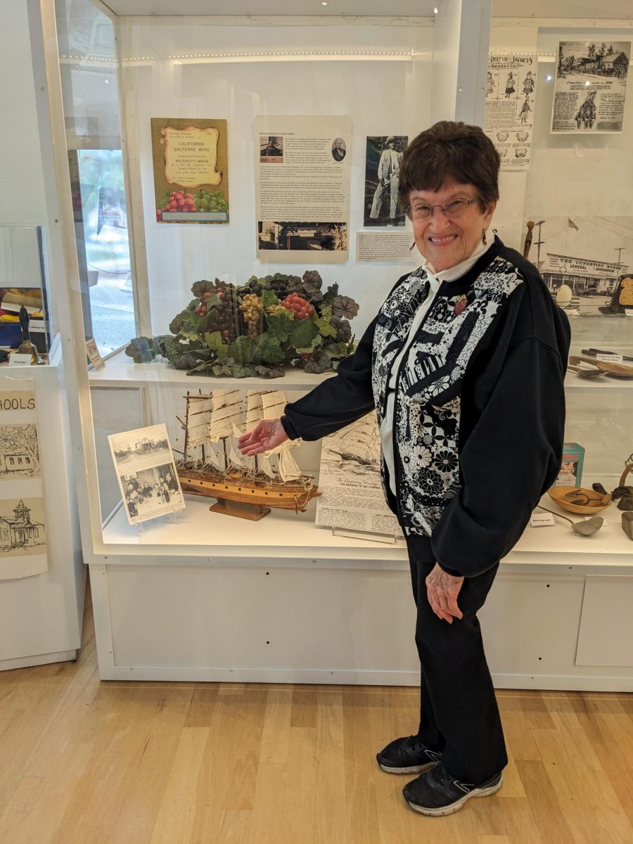 Gail J. Hugger, 80, CHSM historian, gestures to one of the informational displays at the museum.