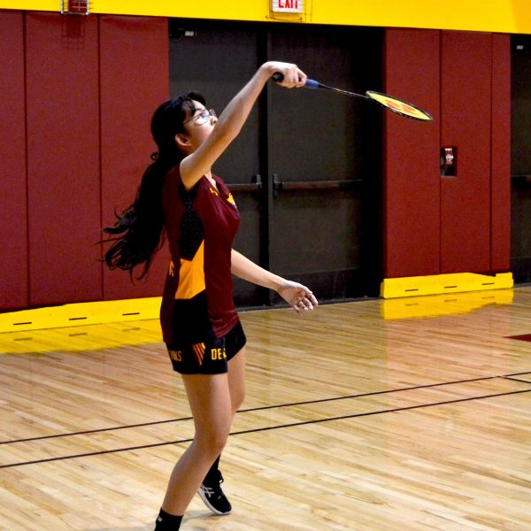 A De Anza badminton player, throwing the flywheel.