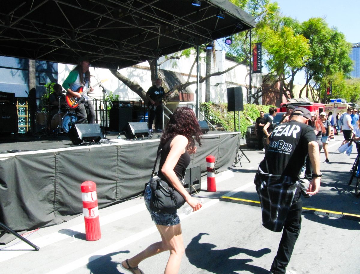 People dance while Drown the Rat, a stoner punk band, perform a song at the Sofa Street Fair in downtown San Jose on April 28.