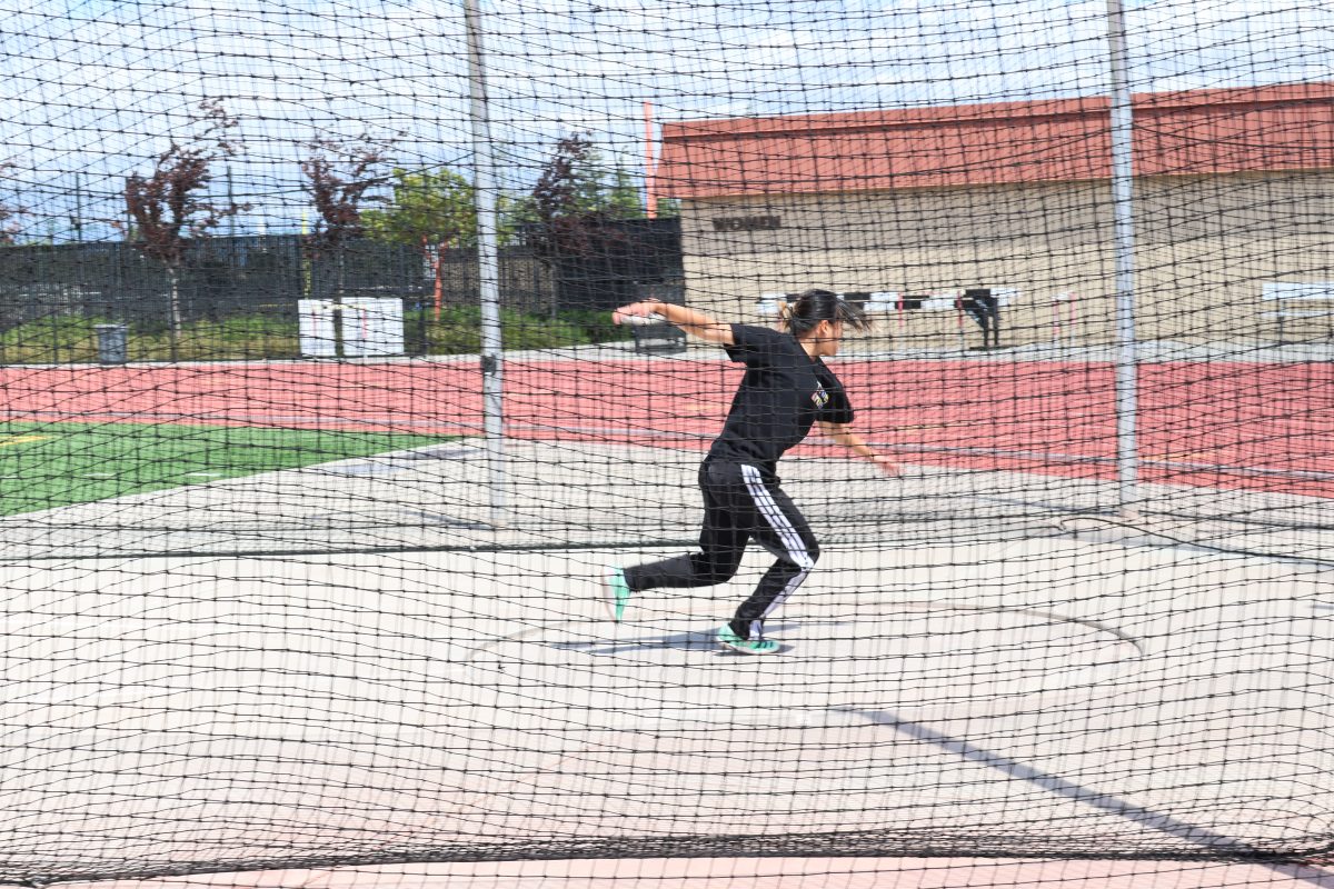 Mylinh Tang, 19, cognitive science major, practicing her discus form at De Anza College on April 25.