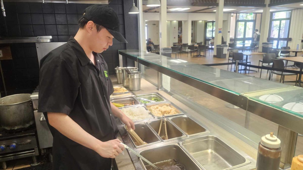 Oliver Tran, 19, a computer science major, works at the Noodle Bar in De Anzas cafeteria on April 22.