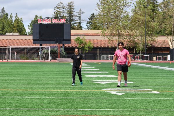 Mylinh Tang, 19, cognitive science major and Liam Brennan, 18, business management major practicing discus before a meet on April 25.