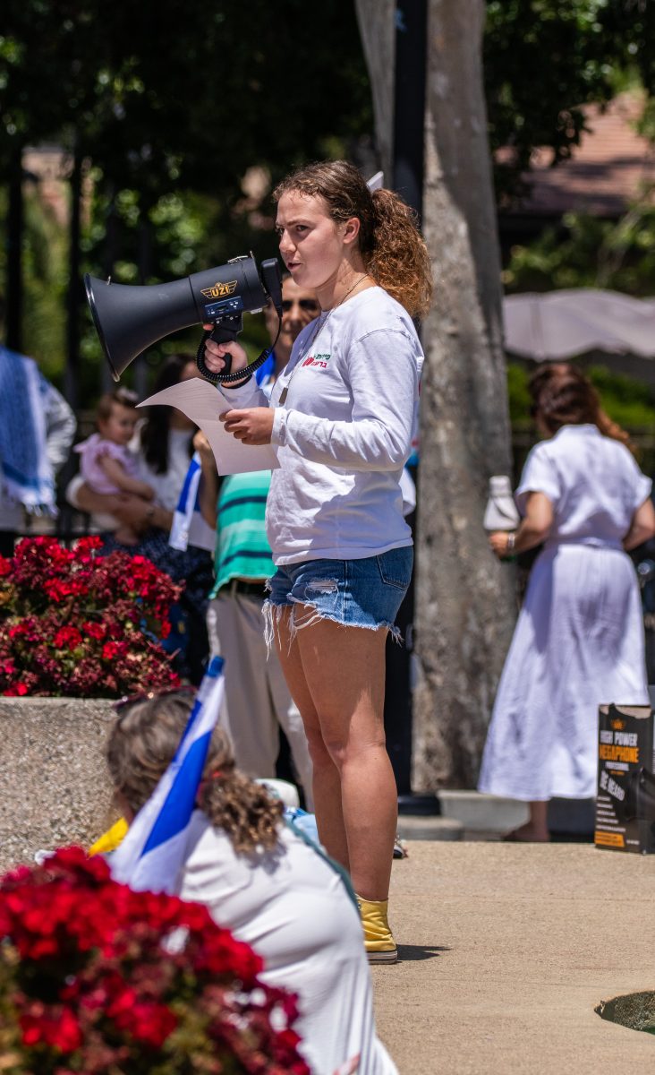 Yael Aharon, 19, whose major is undecided, addresses the crowd using a megaphone.