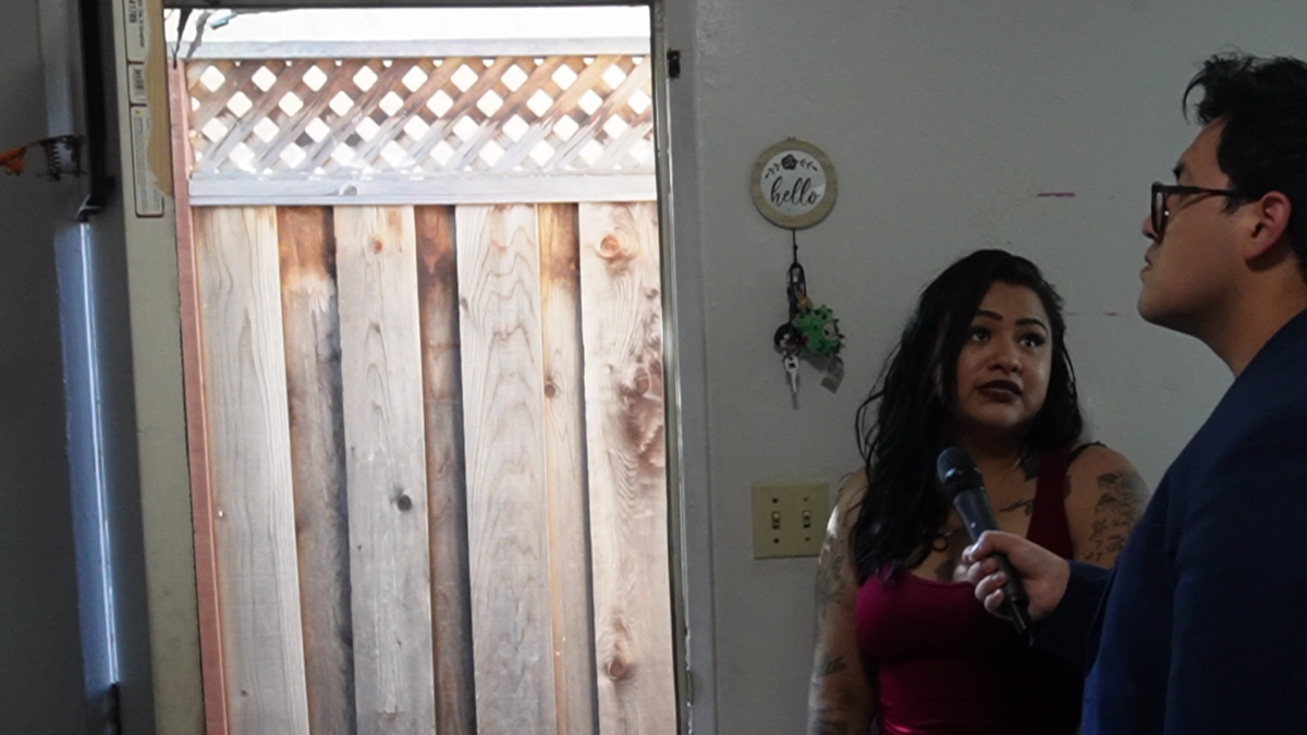 From left, Bianca Aguila demonstrates how she cools down her apartment in San Jose on June 17.