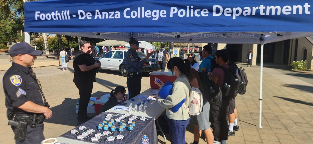 Students gather around the tables and talk to officers while receiving popsicles and free personal alarms on Oct. 2 in the main quad.