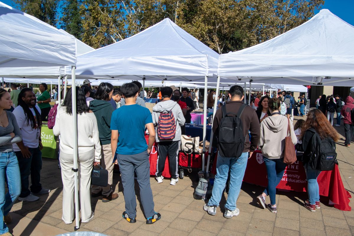 Students gather around Stanford Medicine's table at Transfer Day in the Main quad on Oct. 17.