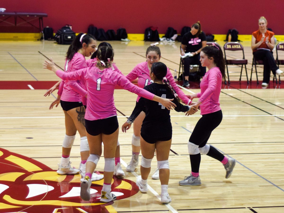 The Mountain Lions regroup and congratulate each other after beating the Skyline College Trojans at the first set, in the Main Gym on Oct. 2.