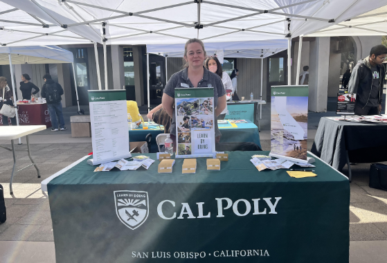 College Counselor Emily Stanton displays her booth promoting the Cal Poly San Luis Obispo transfer program .