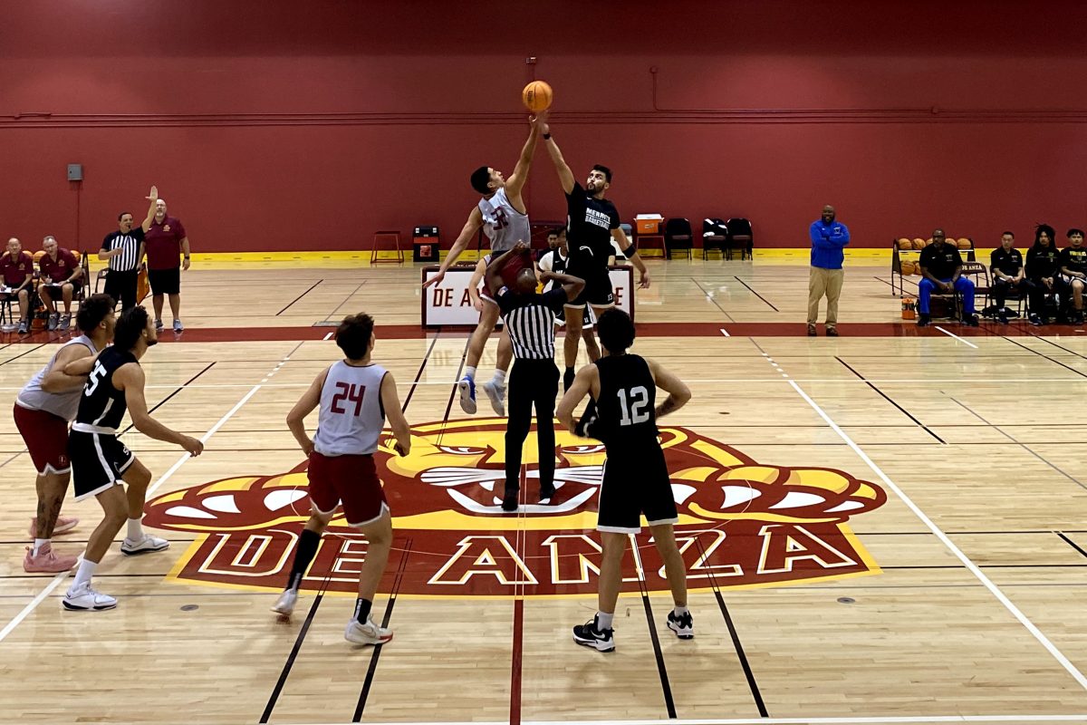 Forward Sean Crowley (De Anza No. 32), 20, a business major, battles for the jump ball against an opponent player from Merritt College at the start of the game on Oct. 25 in the Main Gym.