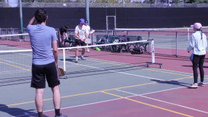 Students play pickleball on the tennis courts as part of a physical education class on Oct. 1.