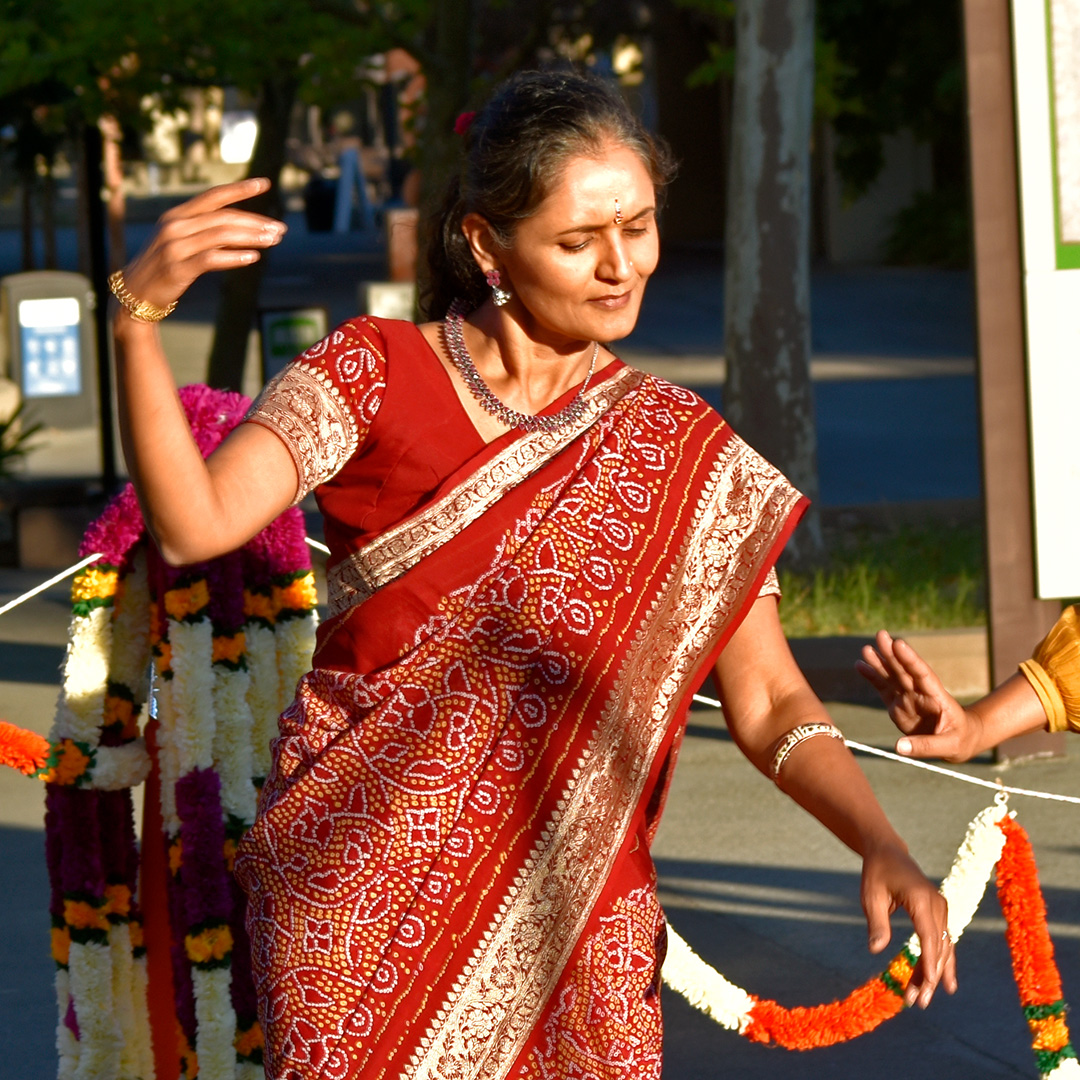 Mathematics Instructor Doli Bambhania dances with fellow staff and students on in the main quad on Oct. 23 during the Diwali festival.