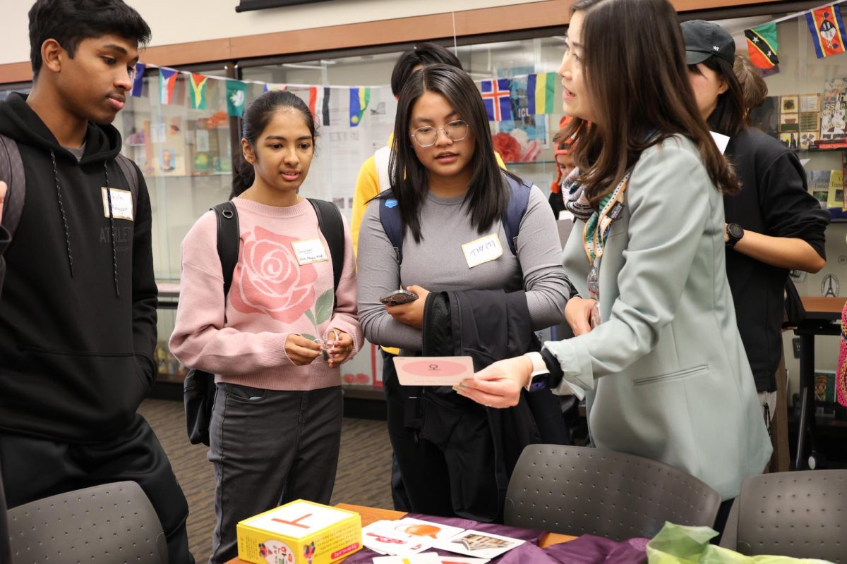 Young Sook Kim, a Korean instructor and world languages coordinator, explains Korean characters to participants at Multicultural Center on Oct. 31.