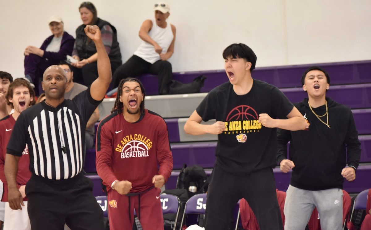 De Anza basketball team and an onlooker celebrate a teammate blocks a critical shot in the game against Lassen College at San Jose City College on Nov. 9.