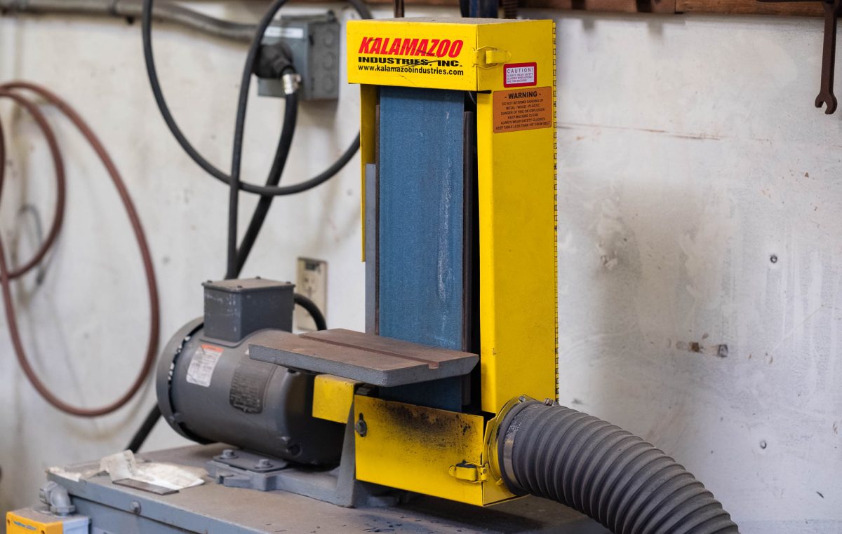 The vertical belt sander involved in the incident on Nov. 6 sits unused with a streak of dried skin and flesh on the belt, photographed on Nov. 19 in A-69, the kiln annex and sculpture yard.