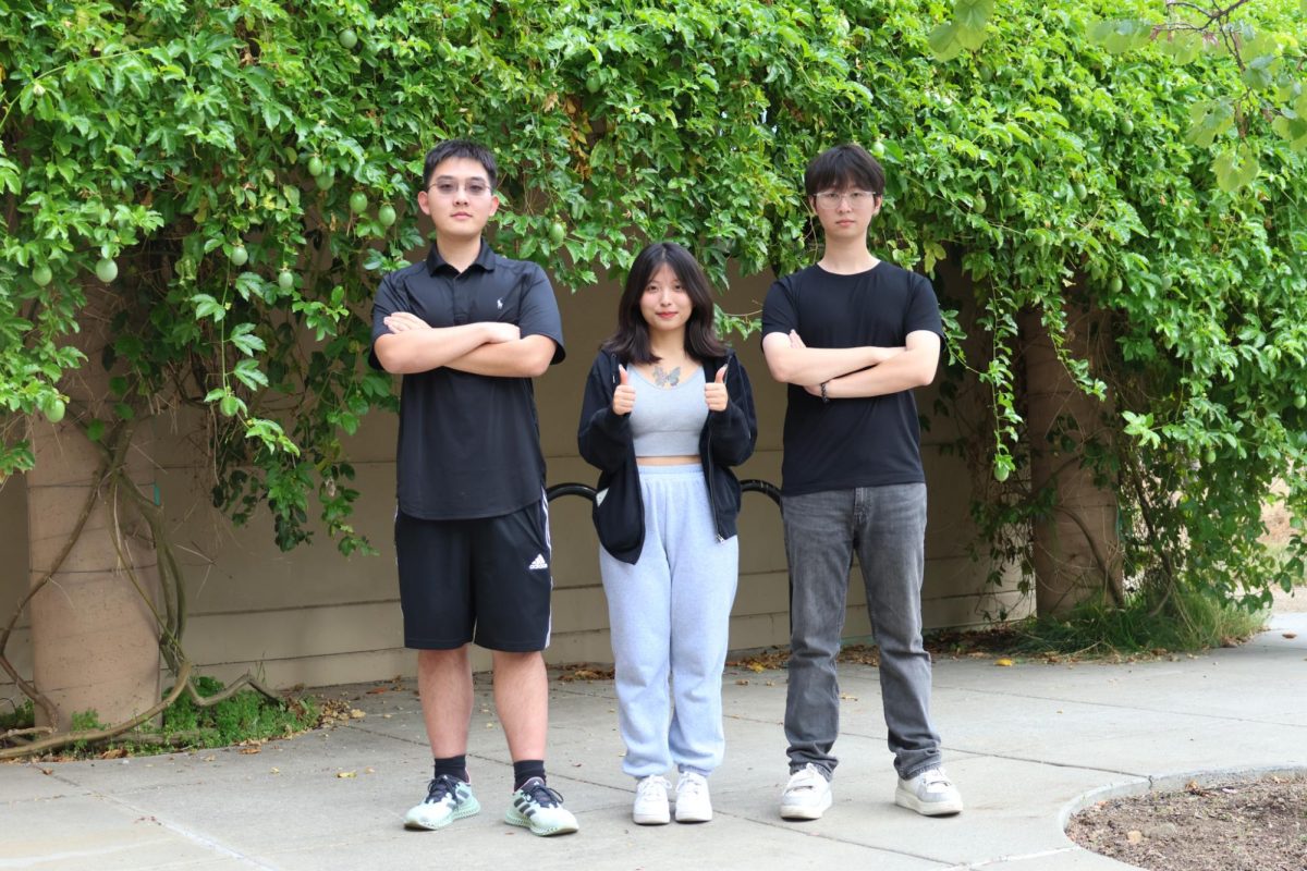 From left, Yuanbo Pang, 19, computer science major, Cecilia Ji, 19, economics major, and Hongming Liu, 22, math major, pose as a group in front of the Kirsch Center on Nov. 1. 