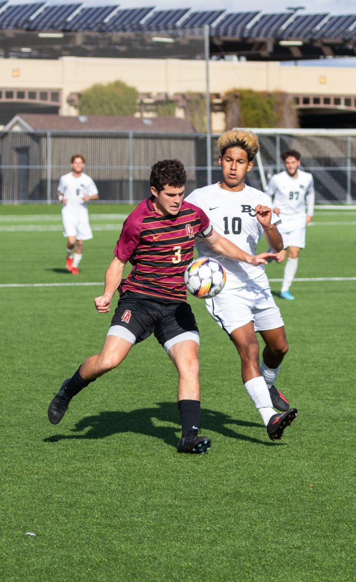 Team captain and defender Whitaker Tollmann (De Anza No. 3), 19, business major, and forward Estefano Garcia (Butte No. 10) chase the ball during the playoff game on Nov. 23 at De Anza College.