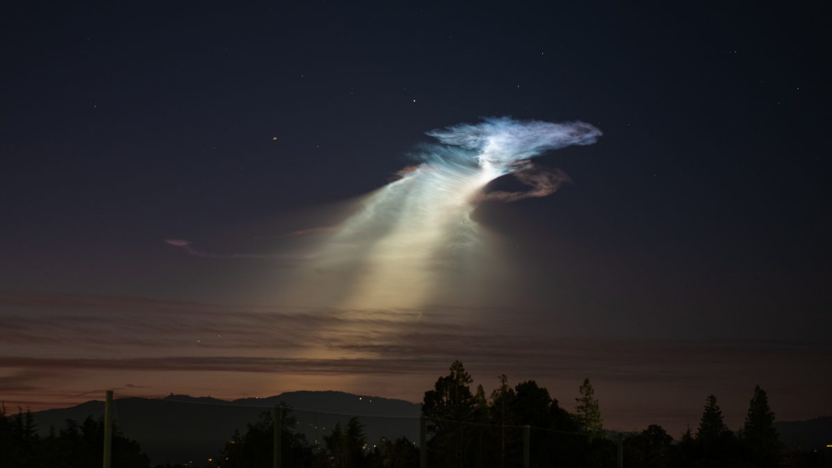 A glowing noctilucent cloud, a rare phenomenon caused by high-altitude clouds illuminated by the sun against a dark sky, hangs over De Anza's soccer field and the mountains south of San Jose following a SpaceX rocket launch, on Jan. 24 at the Stelling Parking Structure