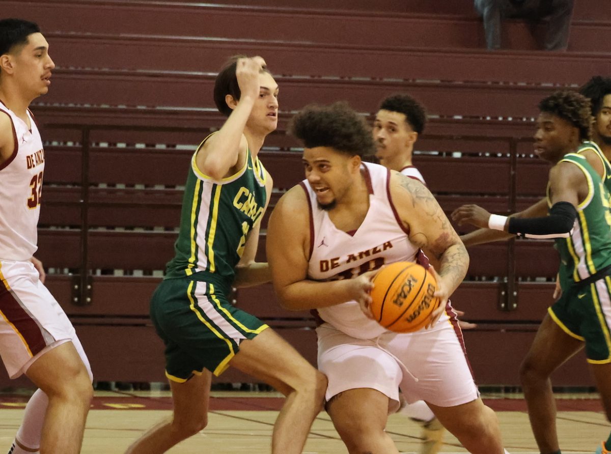 Forward Tre Fields (De Anza No. 30), 20, sociology major, keeps the ball in the De Anza Gymnasium on Jan. 15.